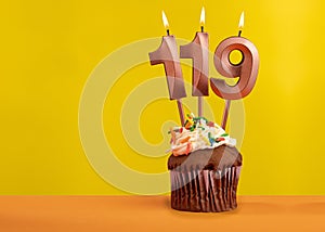 Number 119 birthday candle - Celebration on yellow background