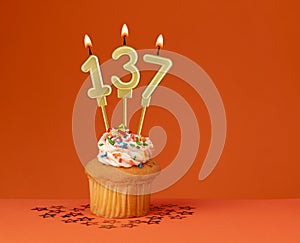 Number 137 candle - Birthday card design in orange background