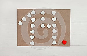 Number 14 formed with hearts white candies on envelope