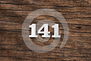 Number 141 in wood, isolated on rustic background