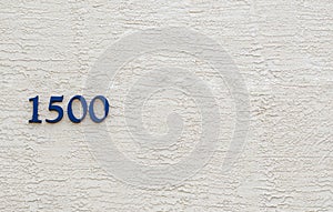The number 1500 against a stucco wall