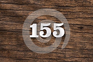 Number 155 in wood, isolated on rustic background