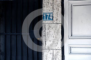 Number 174 sign on tile wall