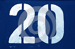 Number 20 in stencil on metal wall in navy blue tone