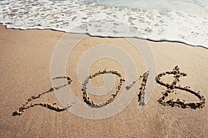 Number 2018 written on the sand in the beach