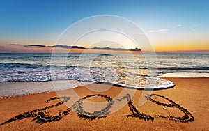 Number 2019 written on seashore sand.