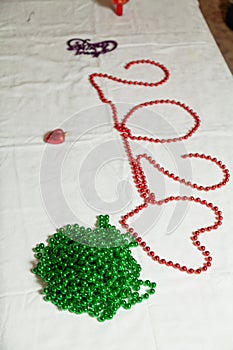 Number 202 laid out of red beads on white background