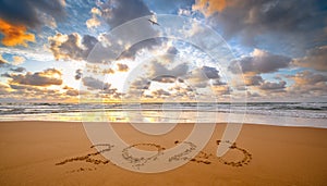 Number 2023 written on seashore sand at sunrise. Concept of upcoming new year and passing of time