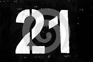 Number 21 in stencil on metal wall in black and white