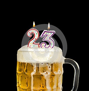 Number 23 candle in beer mug