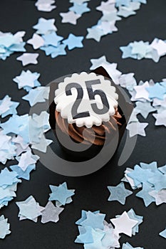 Number 25 on Delicious chocolate cupcake with cream on dark background. Muffin. Birthday cake party. 25 years old
