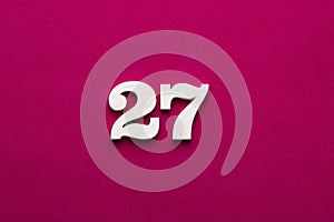 Number 27 - White wooden number on rhodamine red background