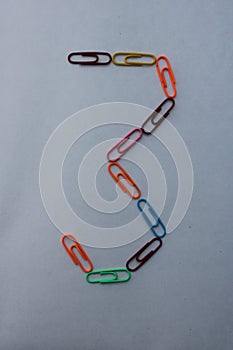 Number 3 made with colorful paper clips on white background