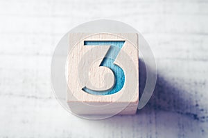 Number 3 On A Wooden Block On A Table