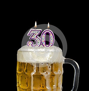 Number 30 candle in beer mug