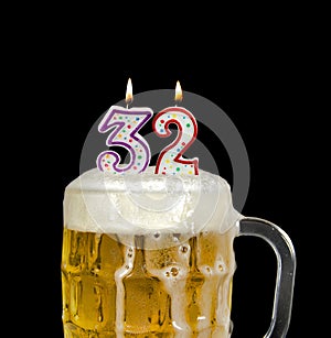 Number 32 candle in beer mug