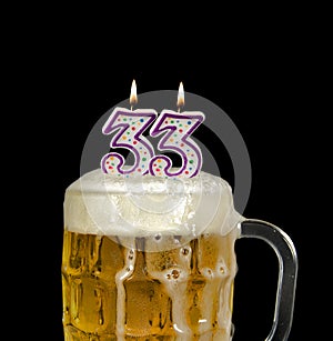 Number 33 candle in beer mug