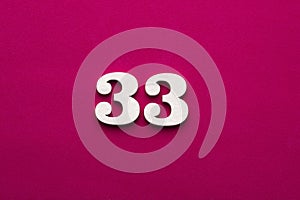 Number 33 - White wooden number on rhodamine red background