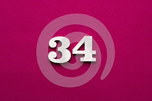 Number 34 - white number in wood on rhodamine red background