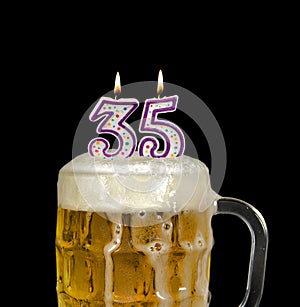 Number 35 candle in beer mug