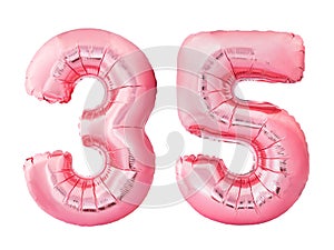 Number 35 thirty five made of rose gold inflatable balloons isolated on white background. Pink helium balloons forming