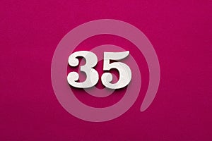 Number 35 - White wooden number on rhodamine red background