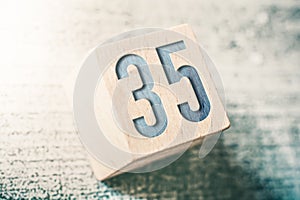 Number 35 On A Wooden Block On A Table