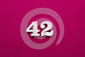 Number 42 - white number in wood on rhodamine red background