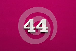 Number 44 - white number in wood on rhodamine red background