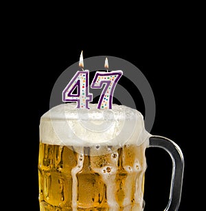 number 47 candle in beer mug