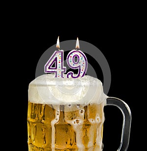 Number 49 candle in beer froth