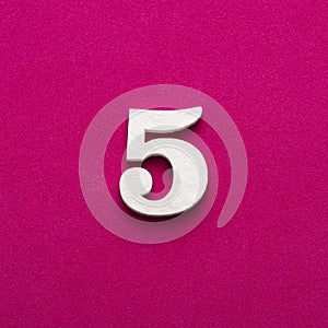 Number 5 - White wooden number on rhodamine red background