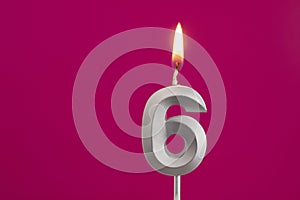 Number 6 - Silver Anniversary Candle on Rhodamine Red Background