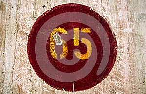 Number 65 painted in a wall of an old train station