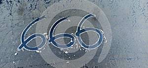 number 666  on frosty car  window background. Hell, death and satan symbol