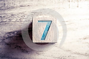 Number 7 On A Wooden Block On A Table