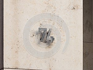 Number 74 on an Exterior House Wall