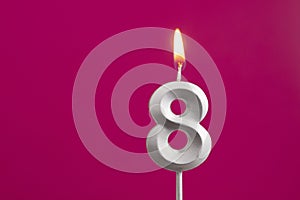 Number 8 - Silver Anniversary Candle on Rhodamine Red Background