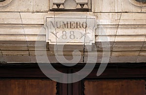 Number 88 sculpted on a stone in Spanish