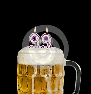 Number 99 candle in beer mug