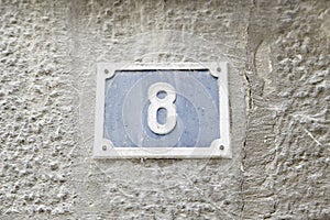 Number eight on the wall of a house