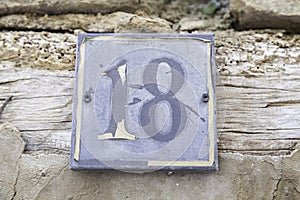 Number eighteen in a wall of a house