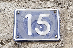 Number fifteen in a wall of a house