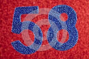 Number fifty-eight blue color over a red background. Anniversary