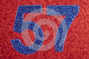 Number fifty-seven blue color over a red background. Anniversary