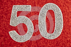 Number fifty silver color over a red background. Anniversary.