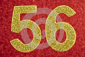 Number fifty-six golden color over a red background. Anniversary