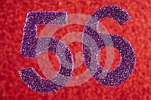Number fifty-six purple color over a red background. Anniversary