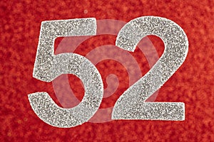 Number fifty-two silver over a red background. Anniversary.