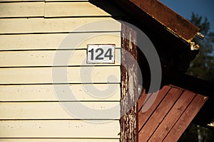 A number of house in the suburbs. House with plastic boards and a roof made of corrugated sheet